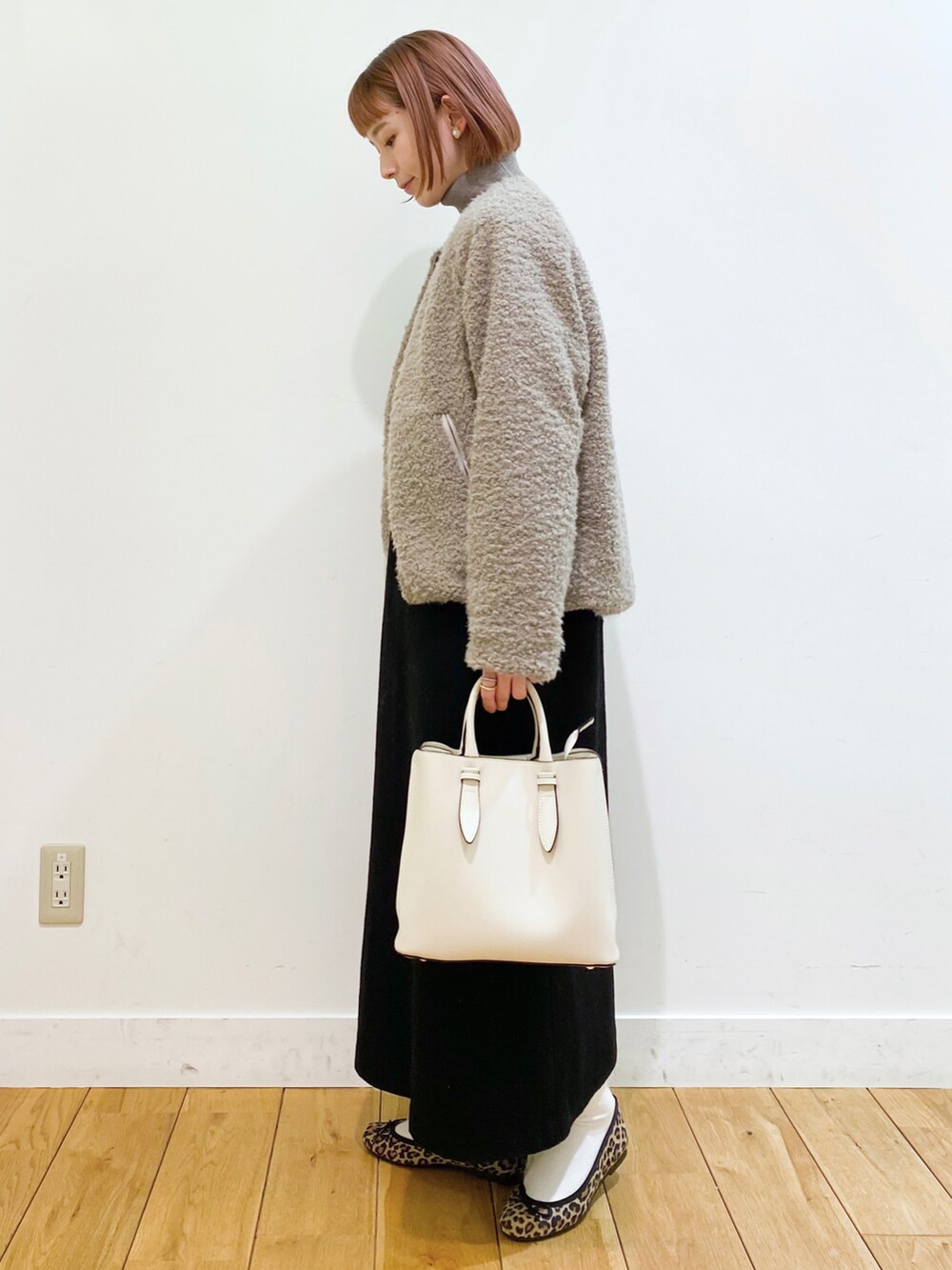 ベージュ系のブルゾン、ブラック系のワンピース、グレー系のニット/セーターを着用したレディースの冬コーディネートの3枚目の写真