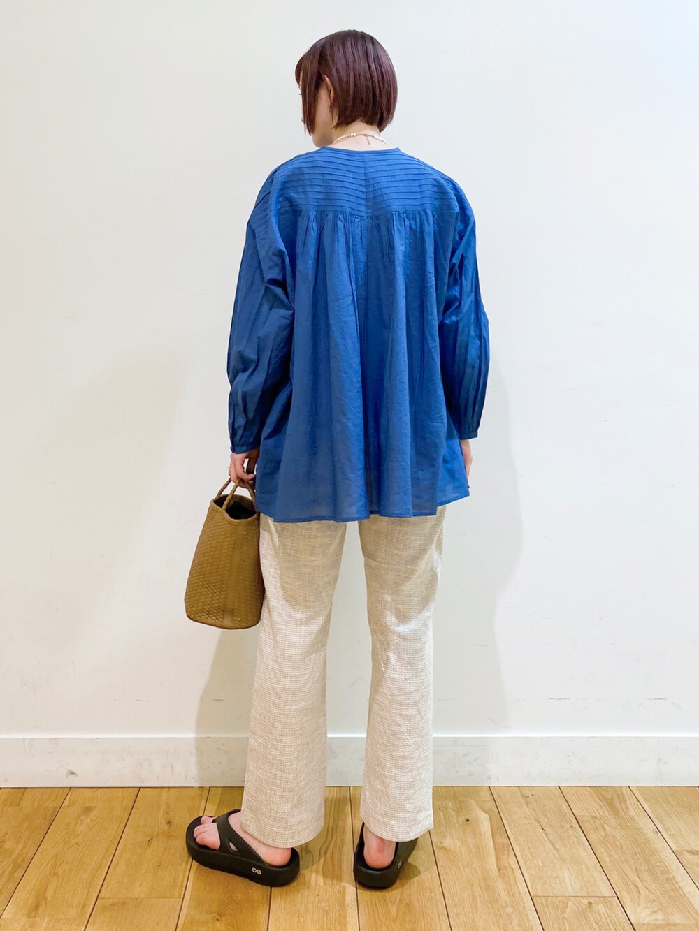 ブルー系のシャツ/ブラウス、イエロー系のハンドバッグ、ホワイト系のその他パンツを着用したレディースの春コーディネートの3枚目の写真