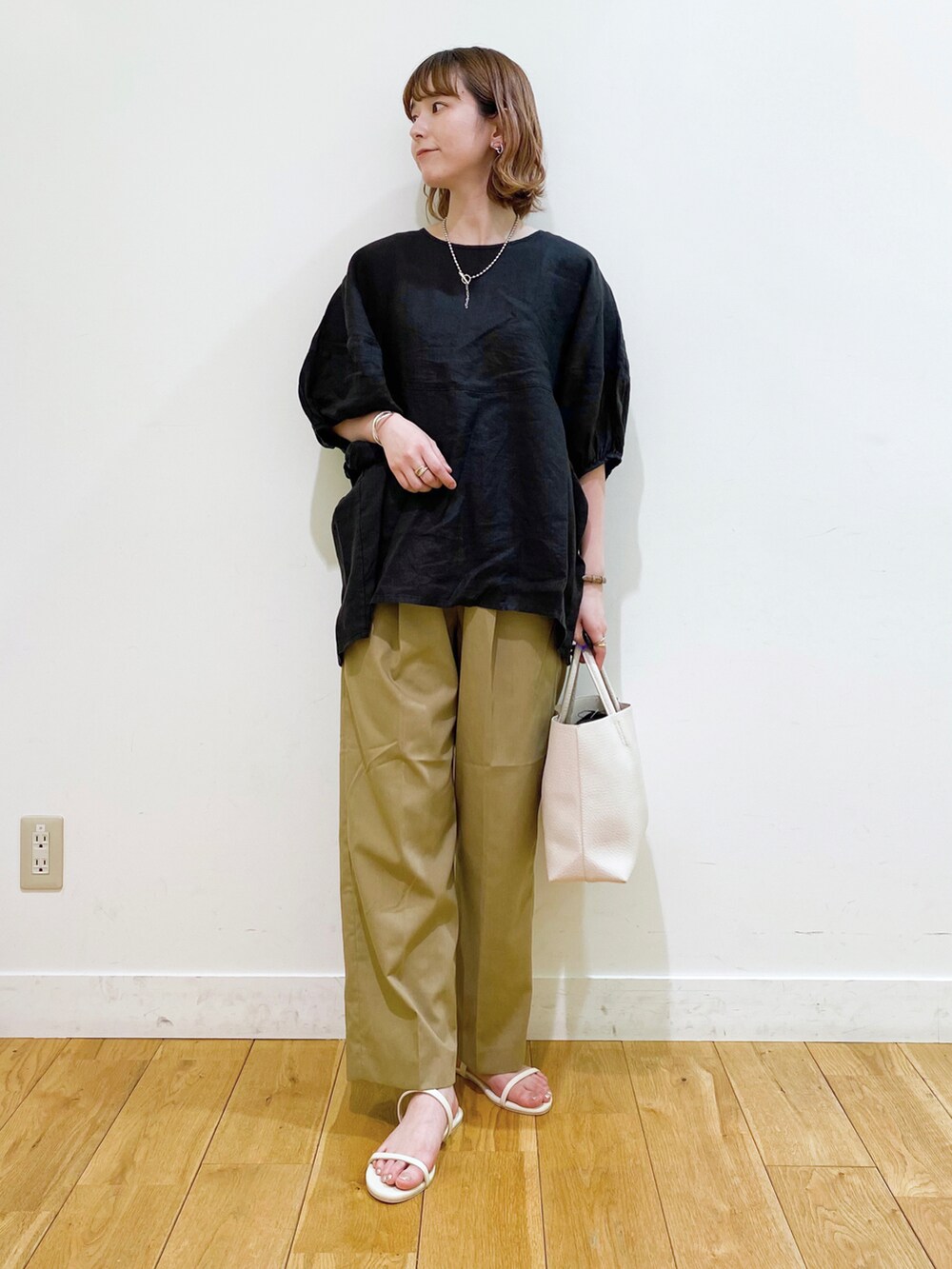 ブラック系のシャツ/ブラウス、ベージュ系のその他パンツ、ホワイト系のサンダルを着用したレディースの夏コーディネートの2枚目の写真