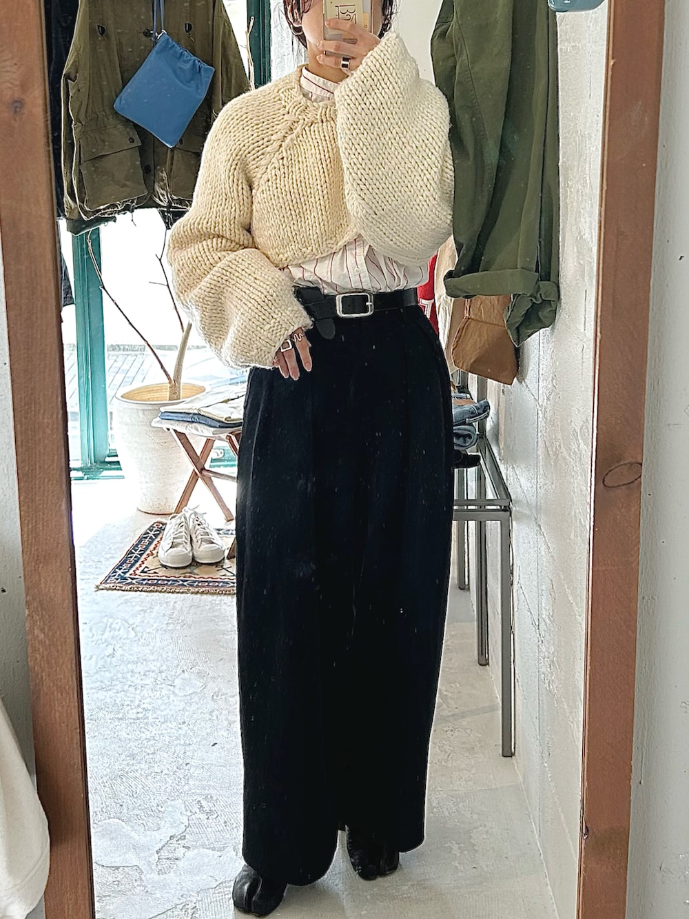 ホワイト系のニット/セーター、ホワイト系のシャツ/ブラウス、ブラック系のその他パンツを着用したレディースの春コーディネートの3枚目の写真