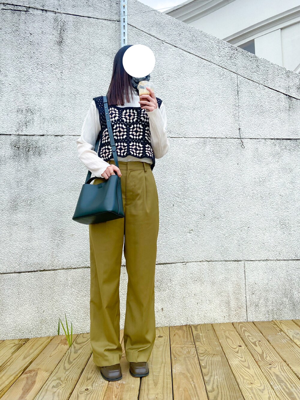 グリーン系のその他パンツ、グリーン系のバッグ、ブラウン系のブーツを着用したレディースの春コーディネートの2枚目の写真