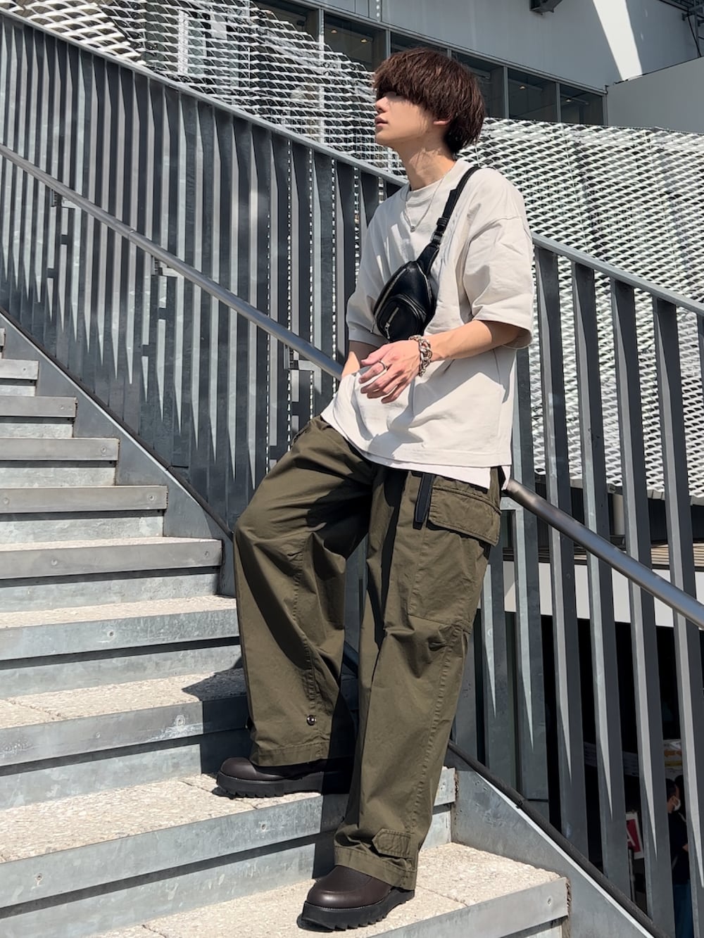 グレー系のTシャツ/カットソー、ホワイト系のタンクトップ、グリーン系のカーゴパンツを着用したメンズの春コーディネートの4枚目の写真