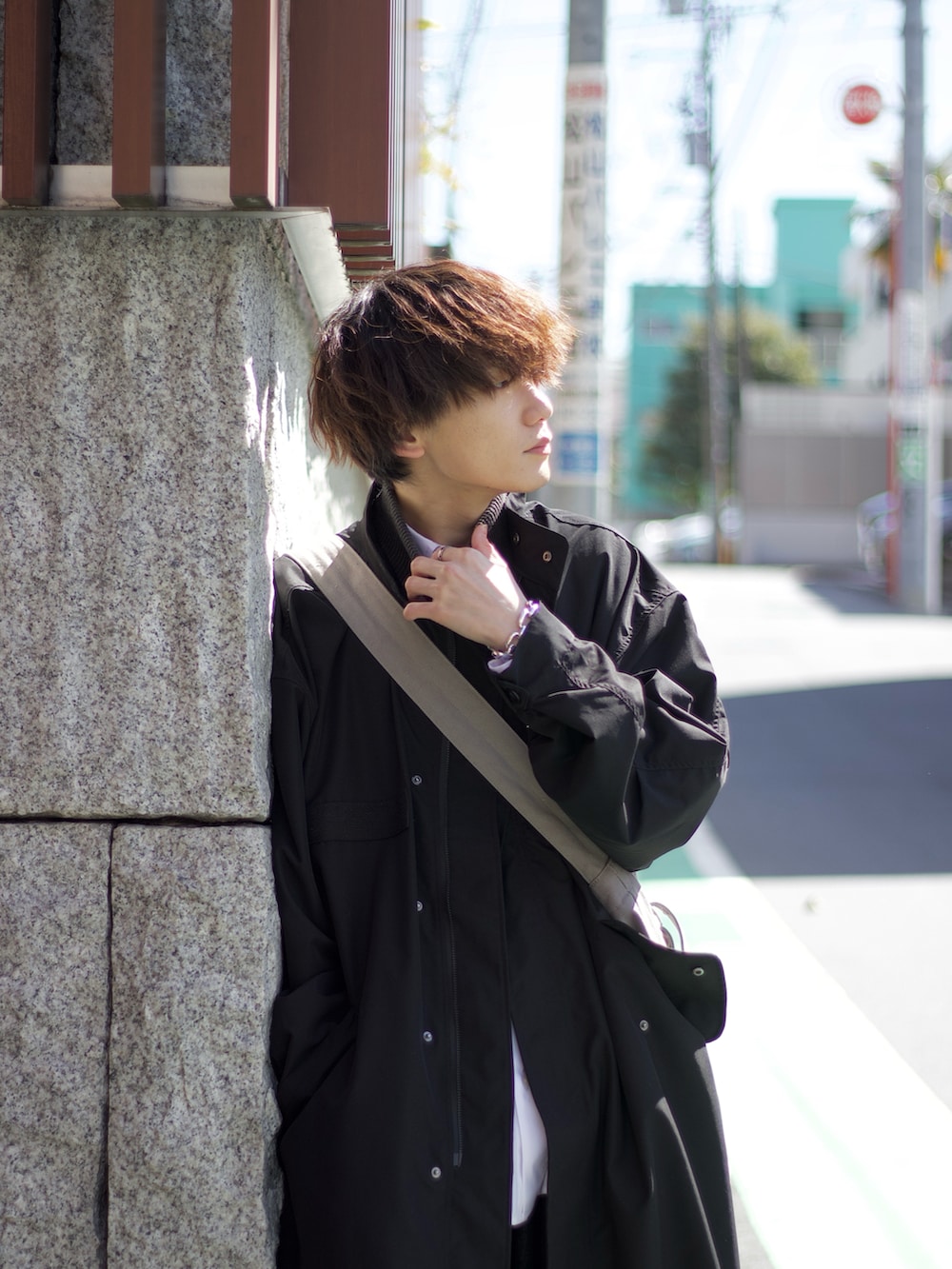 ブラック系のモッズコート、グレー系のベスト、ホワイト系のタンクトップを着用したメンズの春コーディネートの4枚目の写真