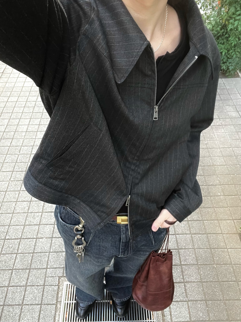 ブラック系のニット/セーター、グレー系のブルゾン、ブルー系のデニムパンツを着用したメンズの冬コーディネートの3枚目の写真