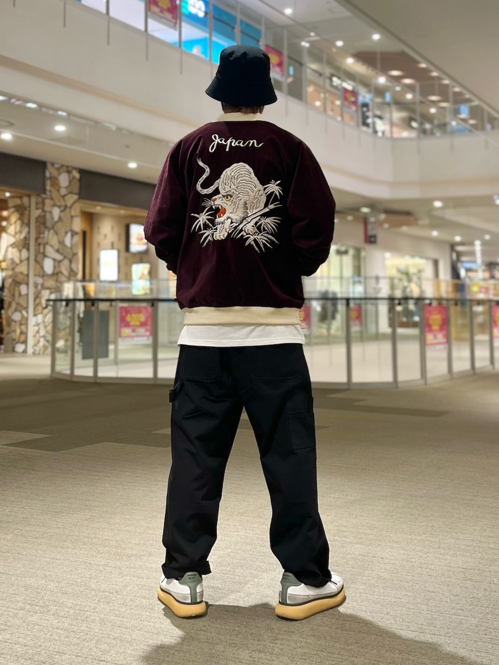 レッド系のスカジャン、ブラック系のその他パンツを着用したメンズの秋コーディネートの2枚目の写真