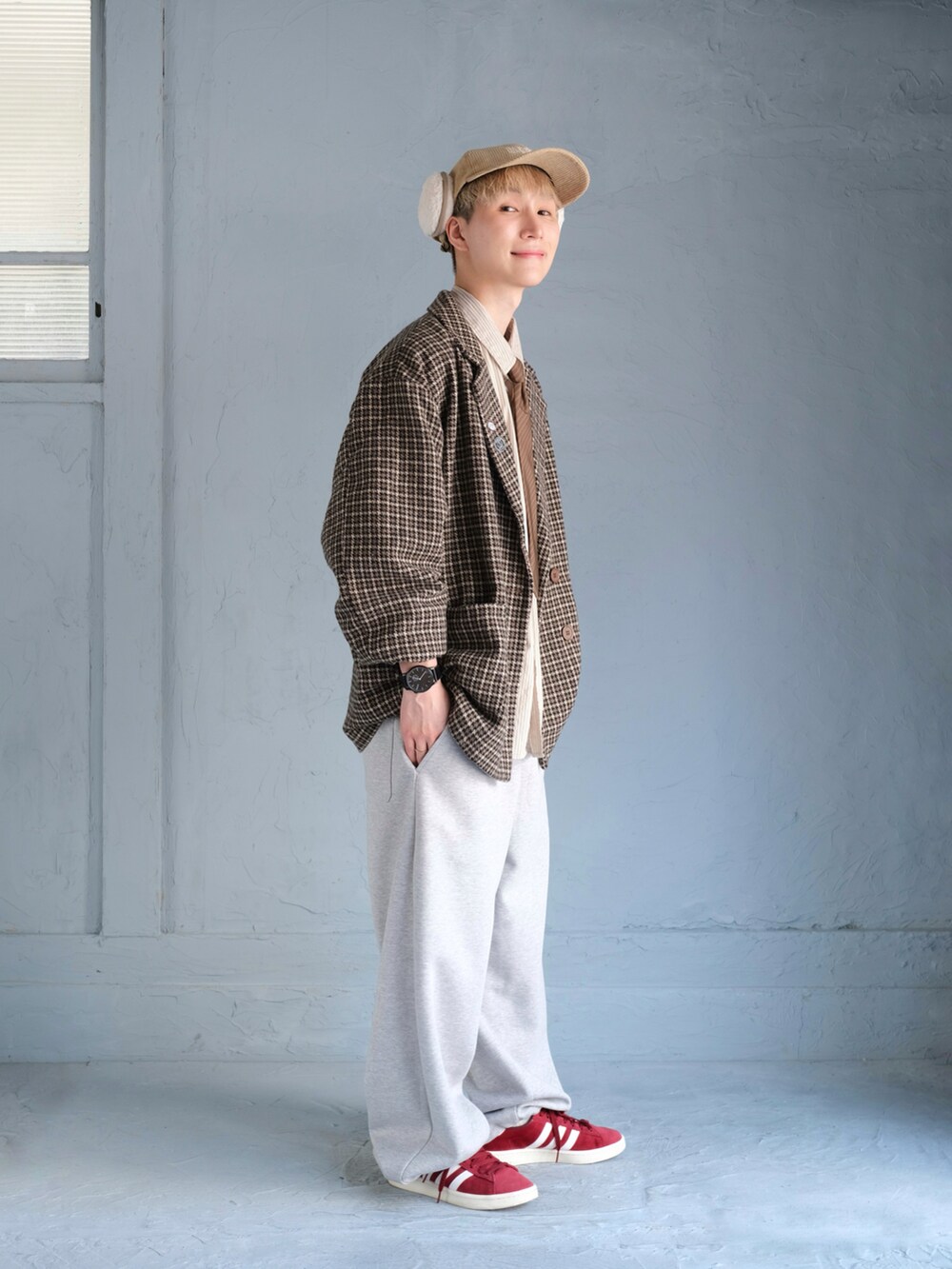 ブラウン系のテーラードジャケット、グレー系のスウェットパンツ、レッド系のスニーカーを着用したメンズの秋コーディネートの4枚目の写真