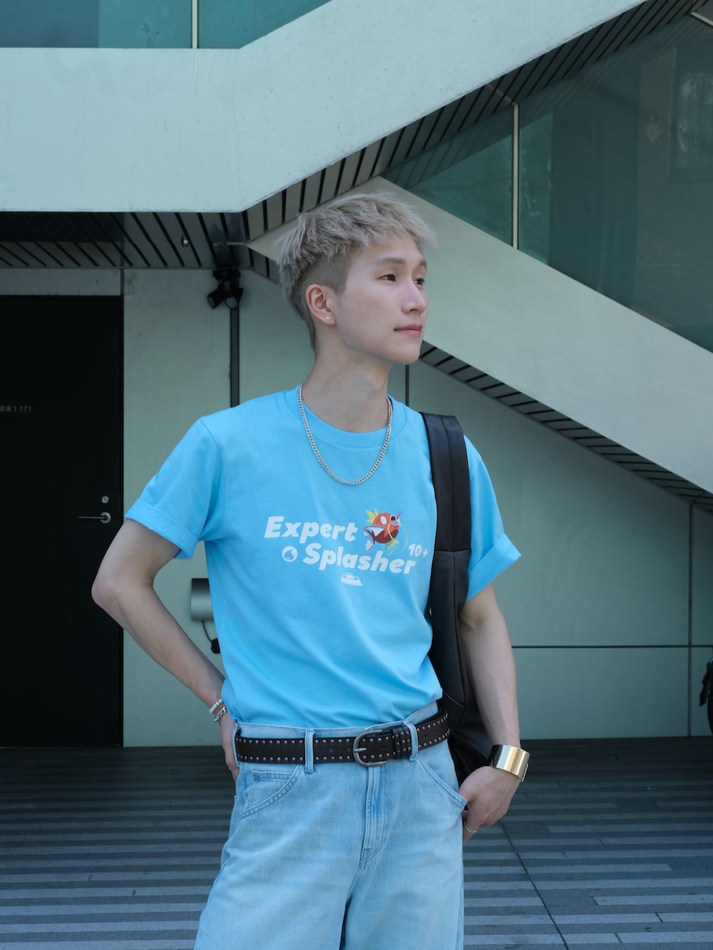 レッド系のスニーカー、ブルー系のTシャツ/カットソー、ブルー系のデニムパンツを着用したメンズの夏コーディネートの3枚目の写真