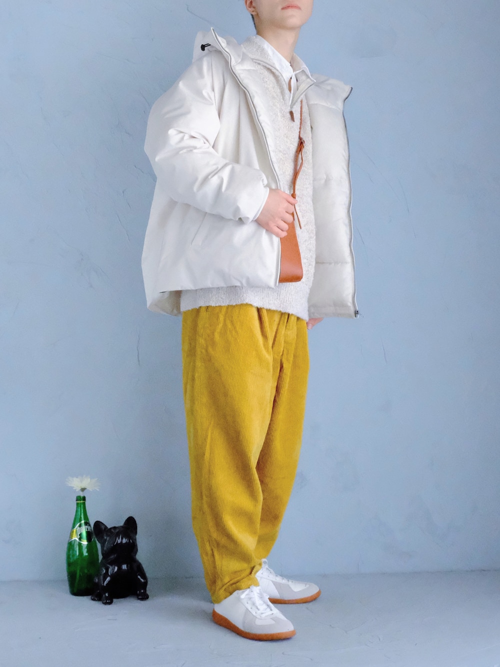 ホワイト系のスニーカー、イエロー系のその他パンツ、オレンジ系のショルダーバッグを着用したメンズの冬コーディネートの2枚目の写真