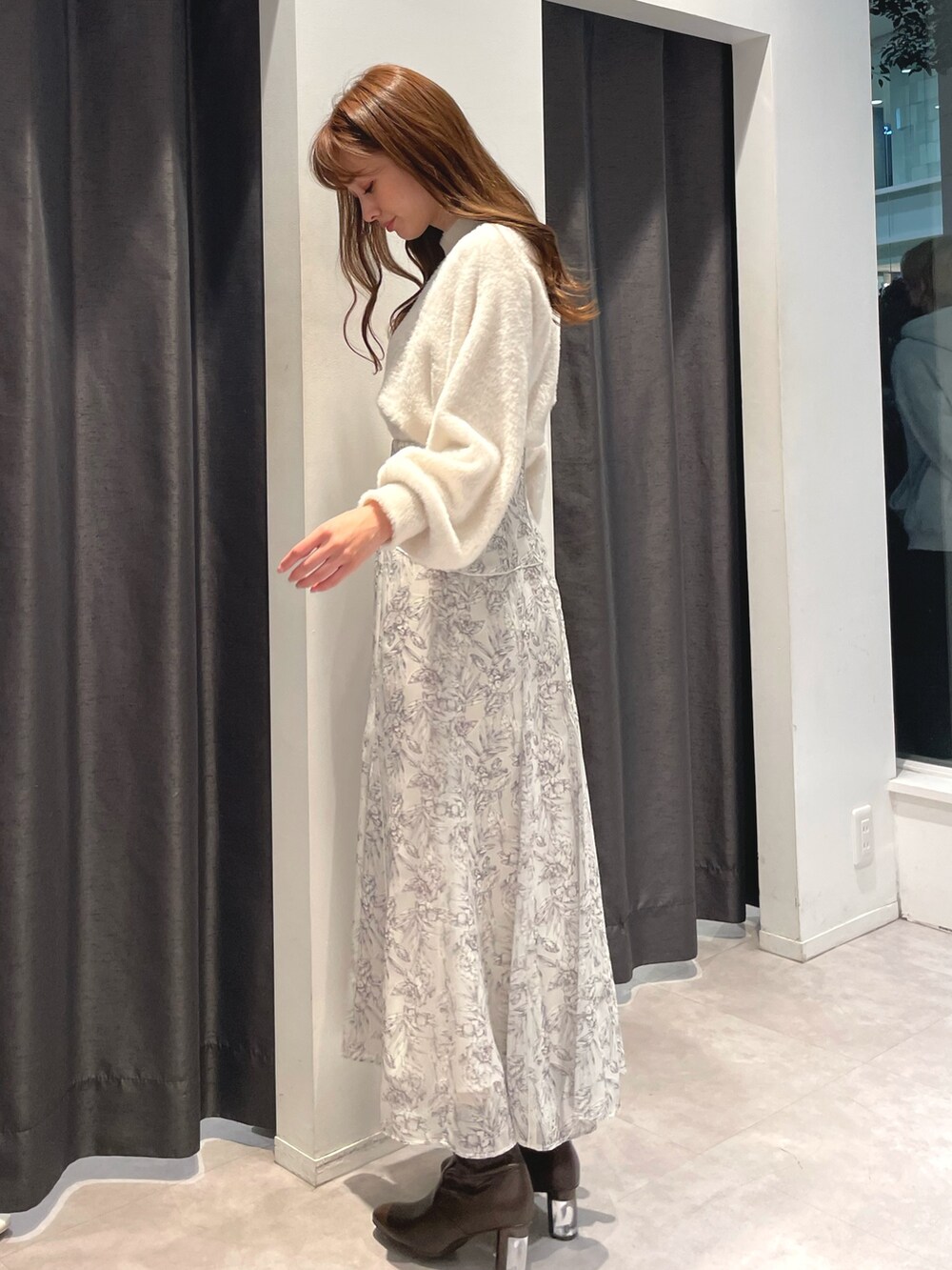 ホワイト系のニット/セーター、ホワイト系のスカート、パープル系のチェスターコートを着用したレディースの秋コーディネートの5枚目の写真