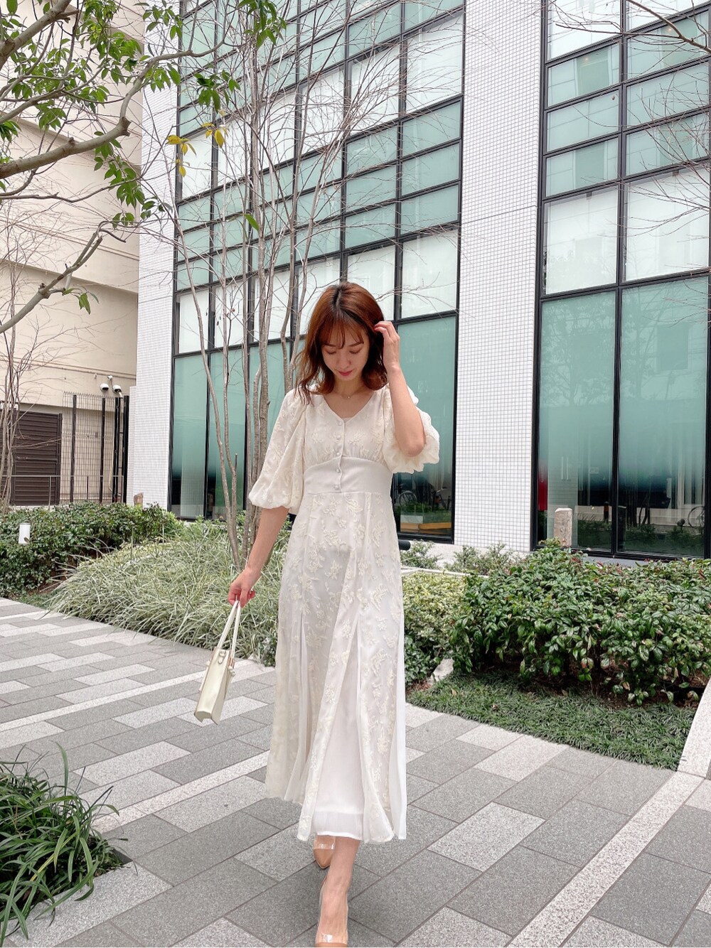 ホワイト系のトレンチコートを着用したレディースの春コーディネートの3枚目の写真