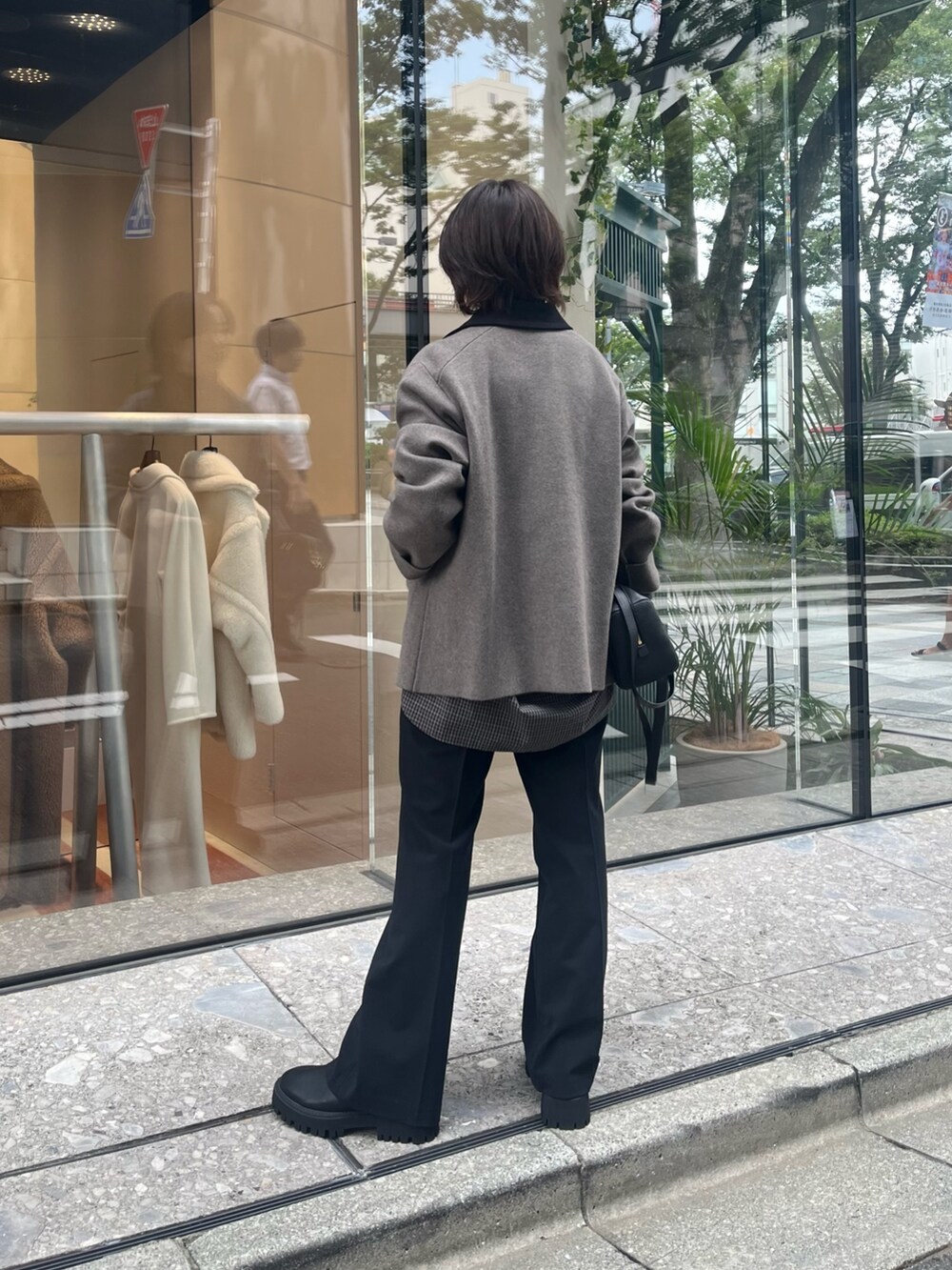 グレー系のニット/セーター、ブラック系のシャツ/ブラウス、ブラック系のブーツを着用したレディースの夏コーディネートの3枚目の写真