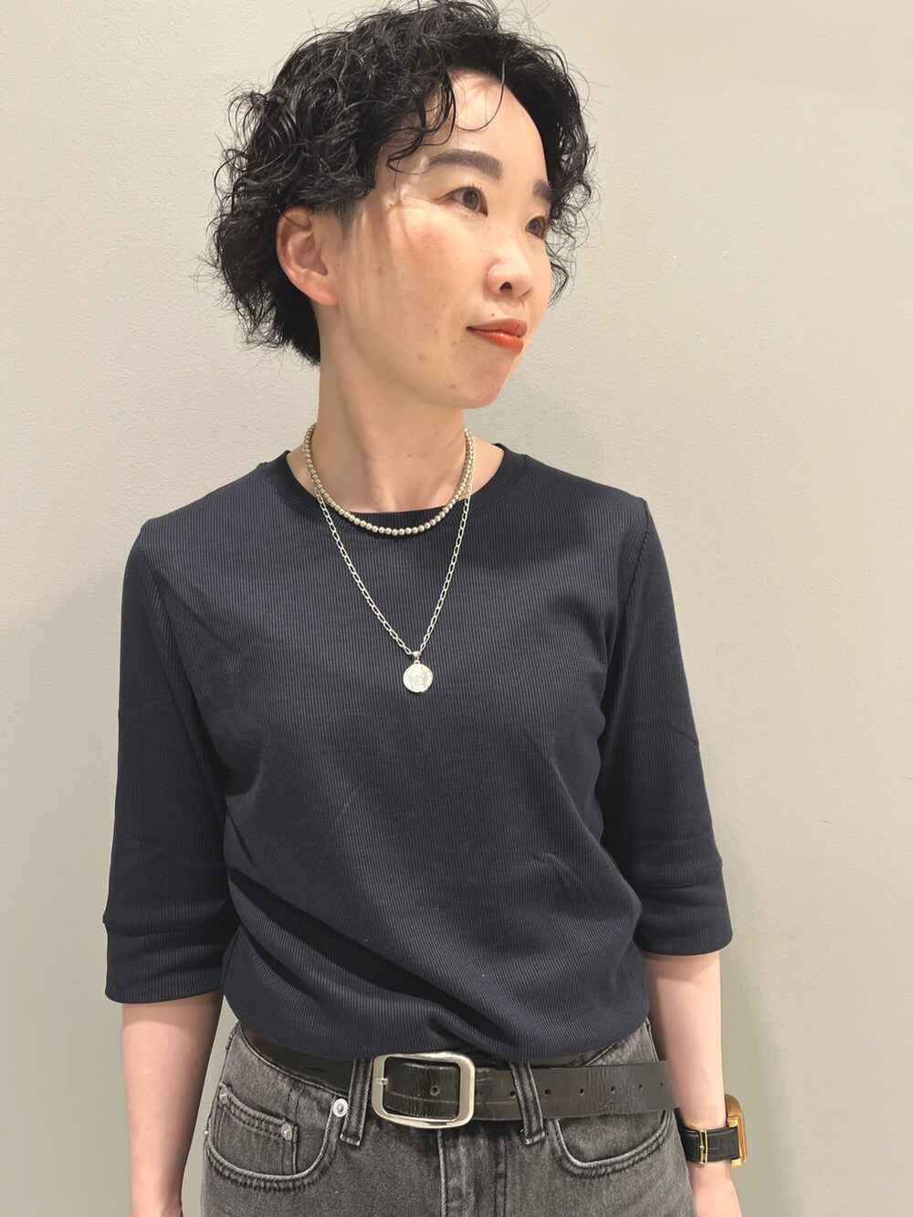 グレー系のデニムパンツ、ブルー系のTシャツ/カットソー、ブラック系のハンドバッグを着用したレディースの夏コーディネートの4枚目の写真