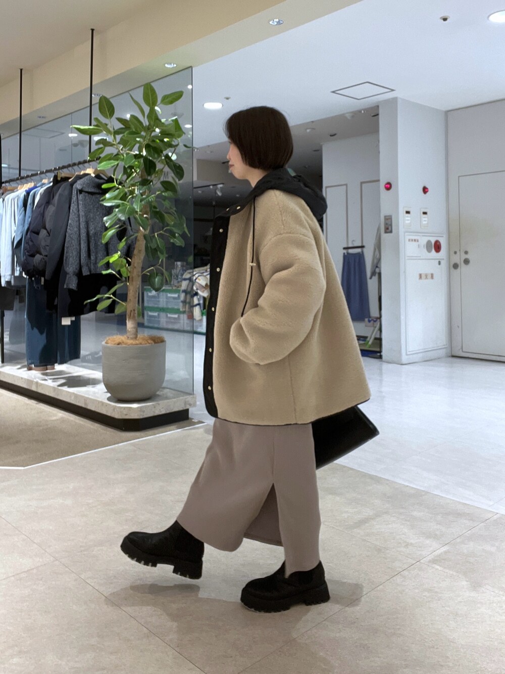 ベージュ系のその他アウター、ホワイト系のニット/セーター、ベージュ系のワンピースを着用したレディースの冬コーディネートの2枚目の写真