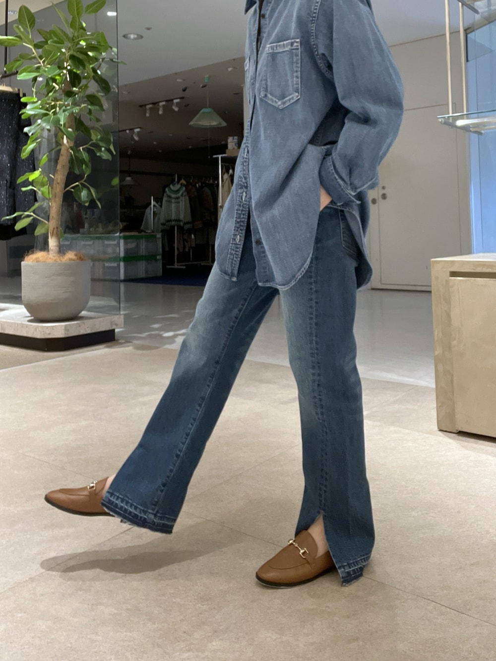 ブルー系のシャツ/ブラウス、ブルー系のデニムパンツ、イエロー系のボストンバッグを着用したレディースの冬コーディネートの8枚目の写真