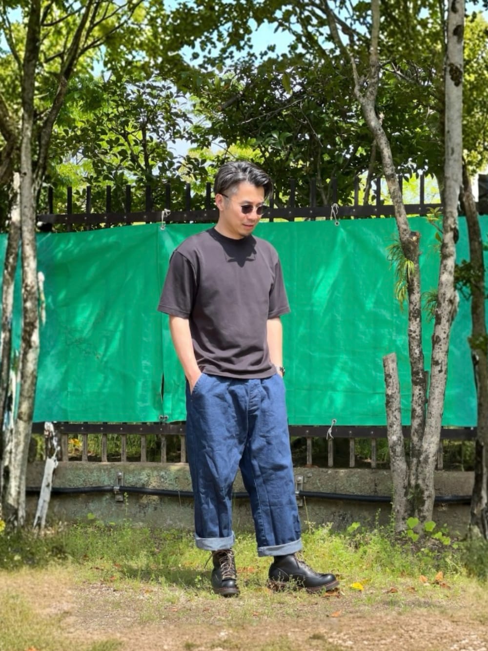 ブルー系のデニムパンツ、グレー系のTシャツ/カットソー、ブラック系のブーツを着用したメンズの春コーディネートの2枚目の写真