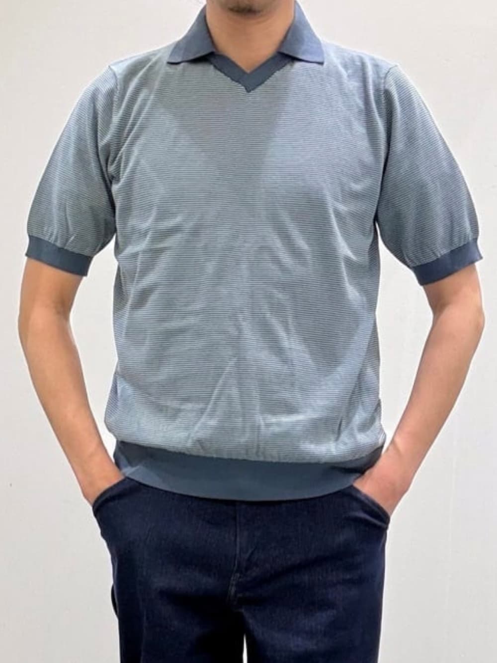 グレー系のスリッポン、ブルー系のテーラードジャケット、ブルー系のデニムパンツを着用したメンズの夏コーディネートの7枚目の写真