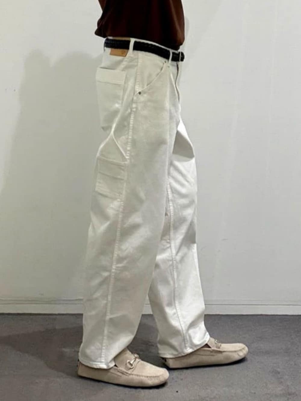 ホワイト系のデニムパンツ、グレー系のスリッポン、ブラウン系のポロシャツを着用したメンズの夏コーディネートの10枚目の写真