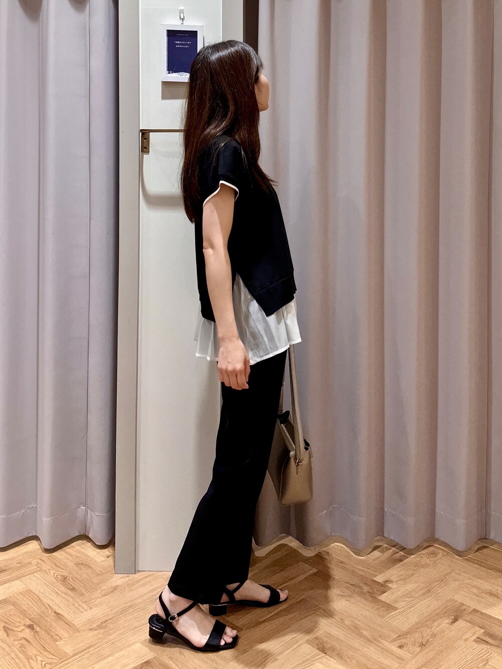 ブラック系のニット/セーター、ブラック系のその他パンツ、シルバー系のショルダーバッグを着用したレディースの夏コーディネートの2枚目の写真