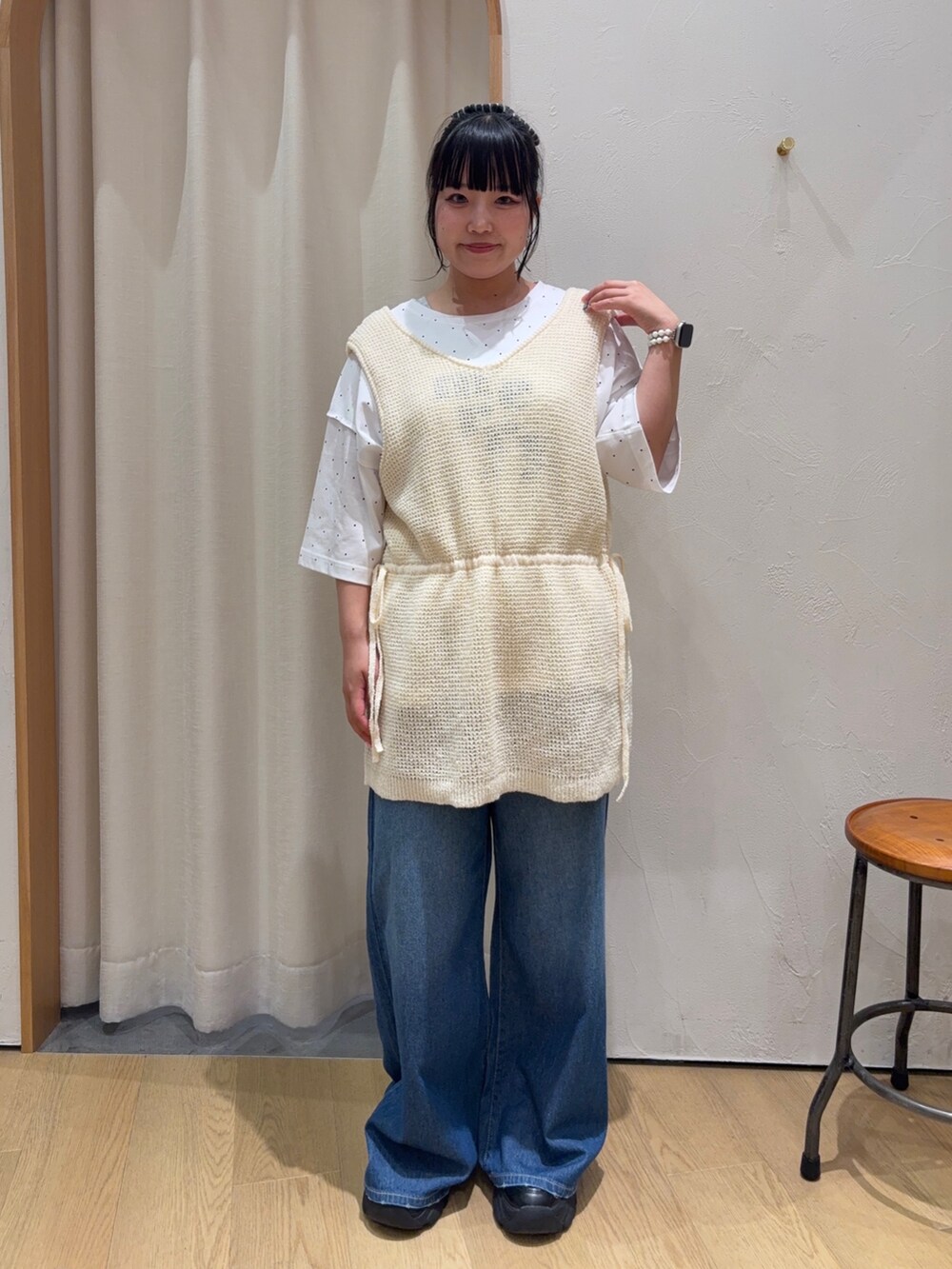 ホワイト系のベスト、ホワイト系のTシャツ/カットソー、ブルー系のデニムパンツを着用したレディースの夏コーディネートの2枚目の写真