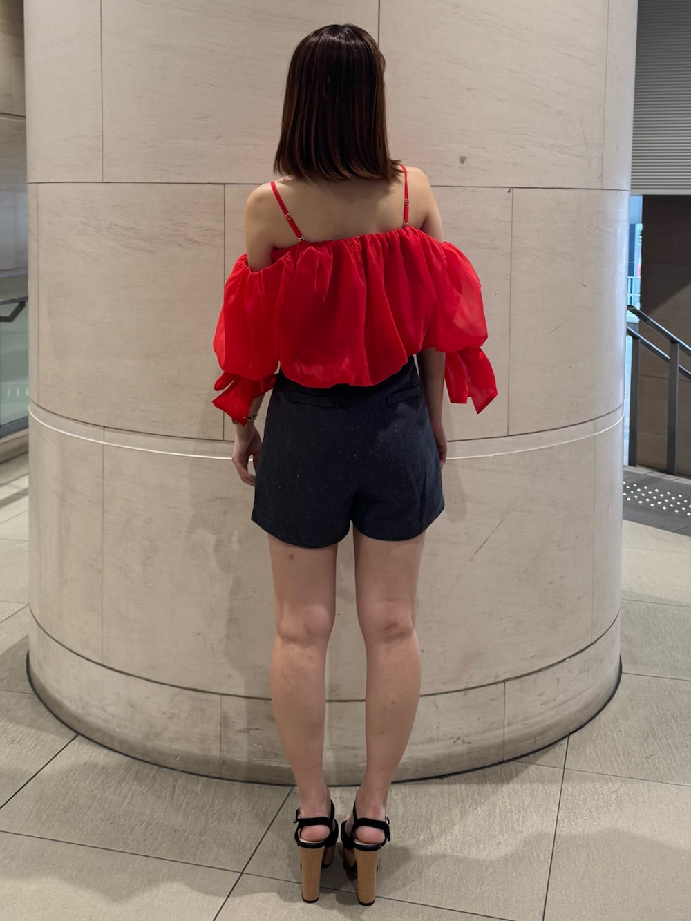 レッド系のシャツ/ブラウス、グレー系のその他パンツ、ブラック系のサンダルを着用したレディースの春コーディネートの3枚目の写真