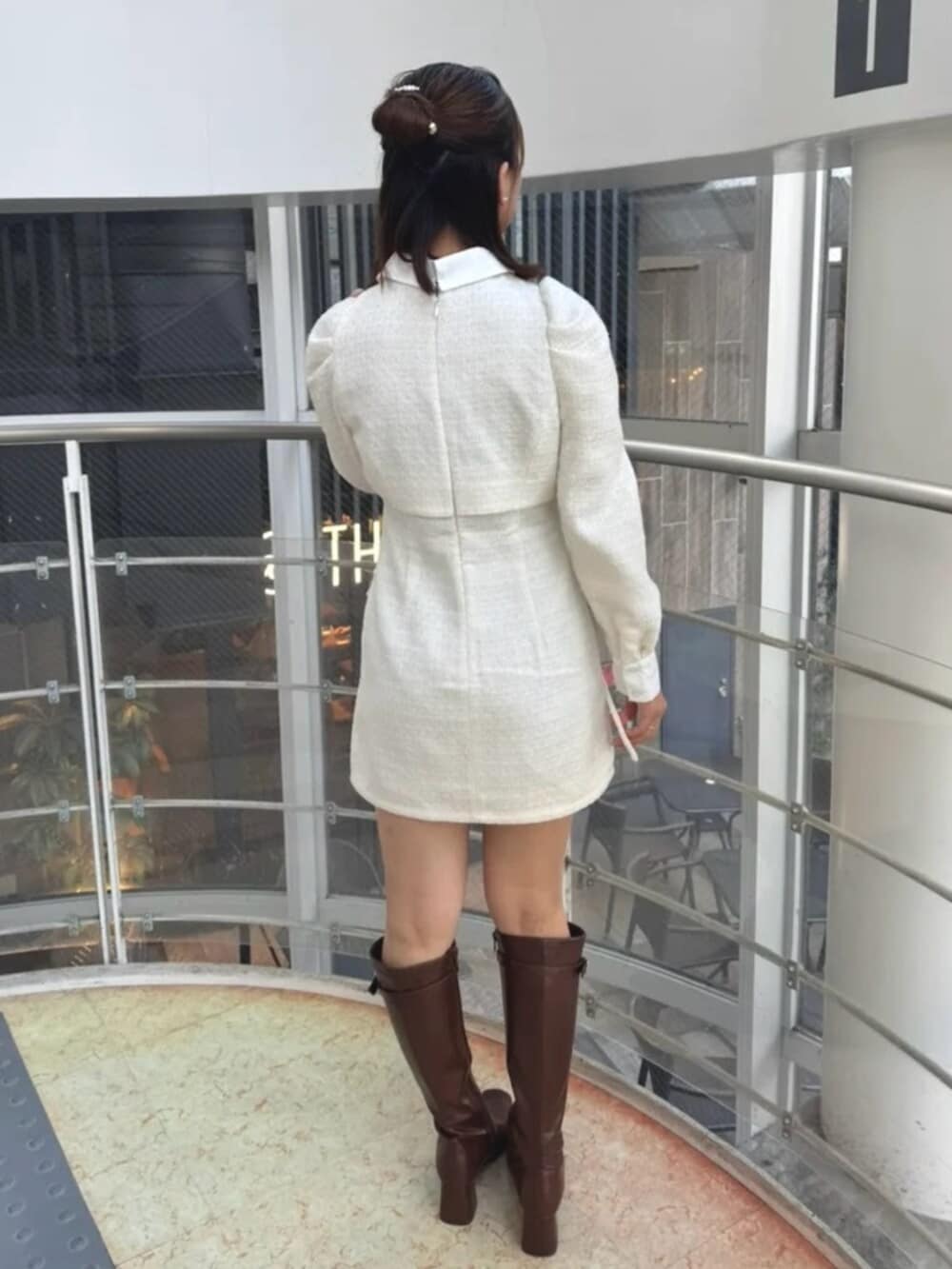 ホワイト系のワンピース、ブラウン系のブーツを着用したレディースの冬コーディネートの3枚目の写真