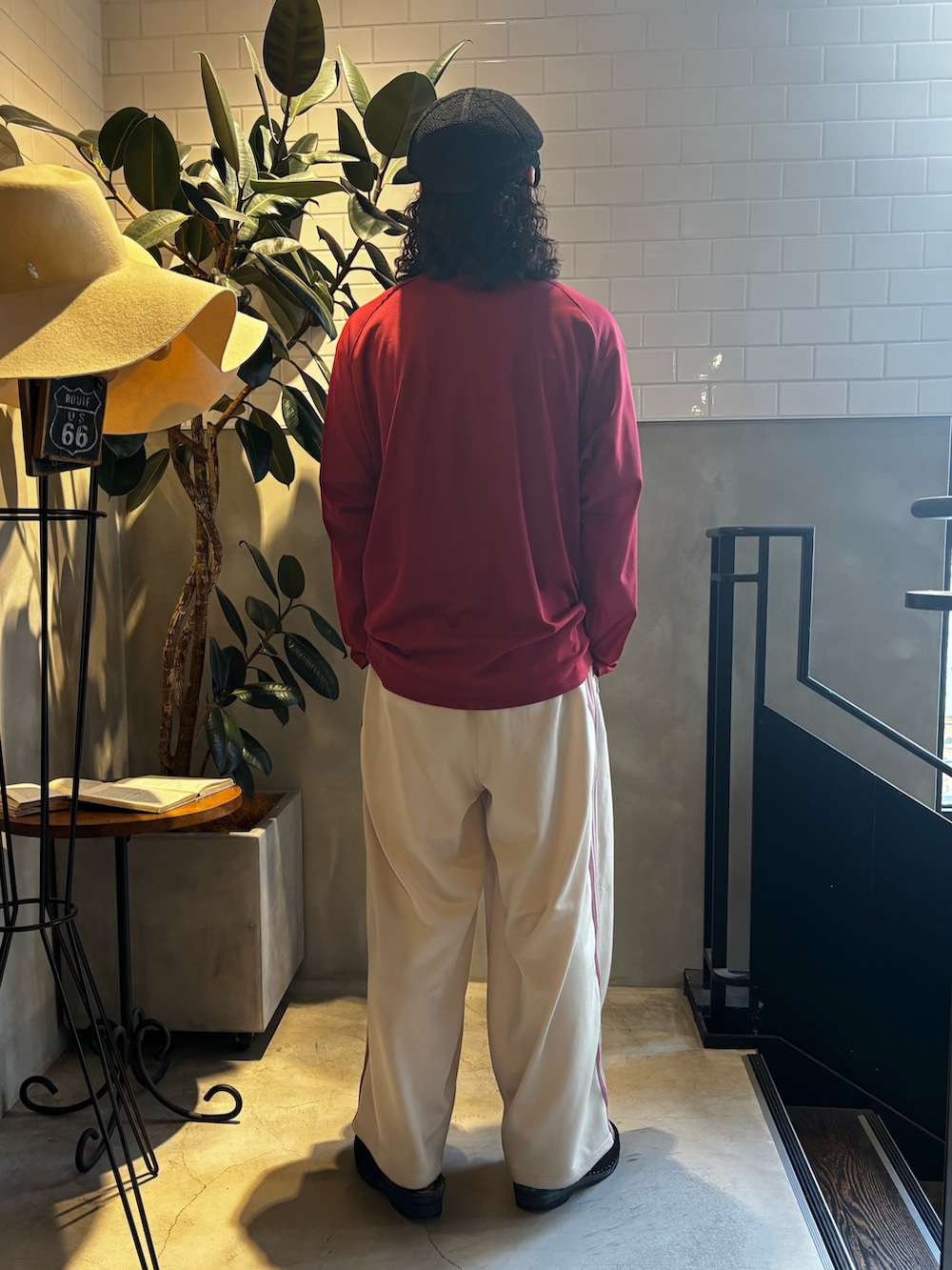 レッド系のニット/セーター、ホワイト系のTシャツ/カットソー、ベージュ系のパンツを着用したメンズの夏コーディネートの5枚目の写真