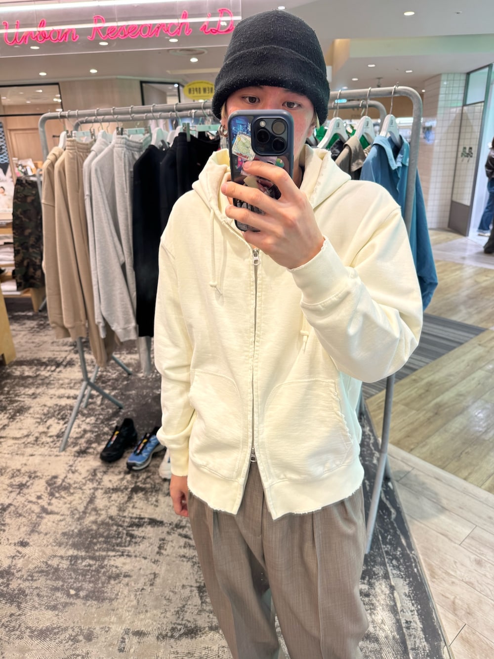 ホワイト系のパーカー、ブラウン系のその他パンツ、シルバー系のスニーカーを着用したメンズの春コーディネートの2枚目の写真