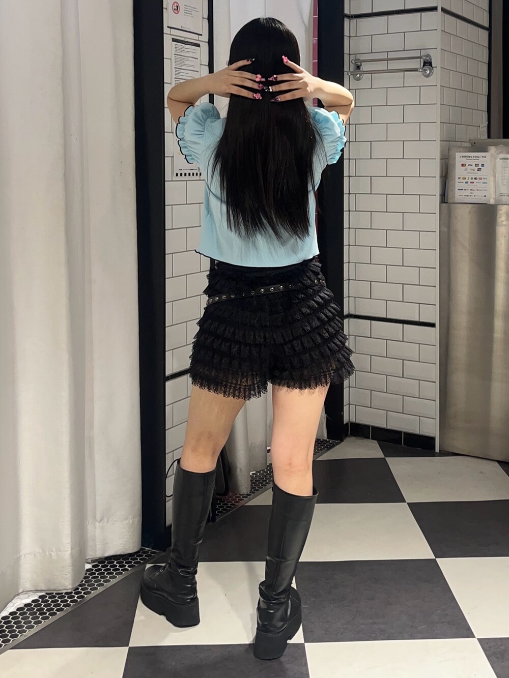 ブルー系のポロシャツ、ブラック系のハンドバッグ、ブラック系のその他パンツを着用したレディースの春コーディネートの3枚目の写真