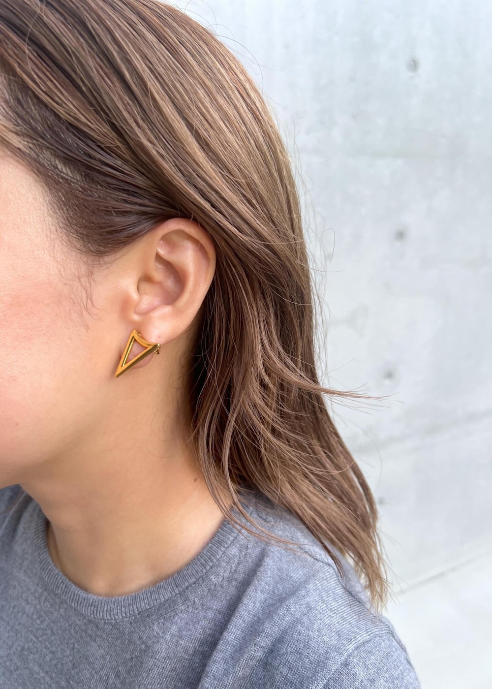 ブラック系のブーツ、ブラック系のスカート、グレー系のベストを着用したレディースの秋コーディネートの6枚目の写真