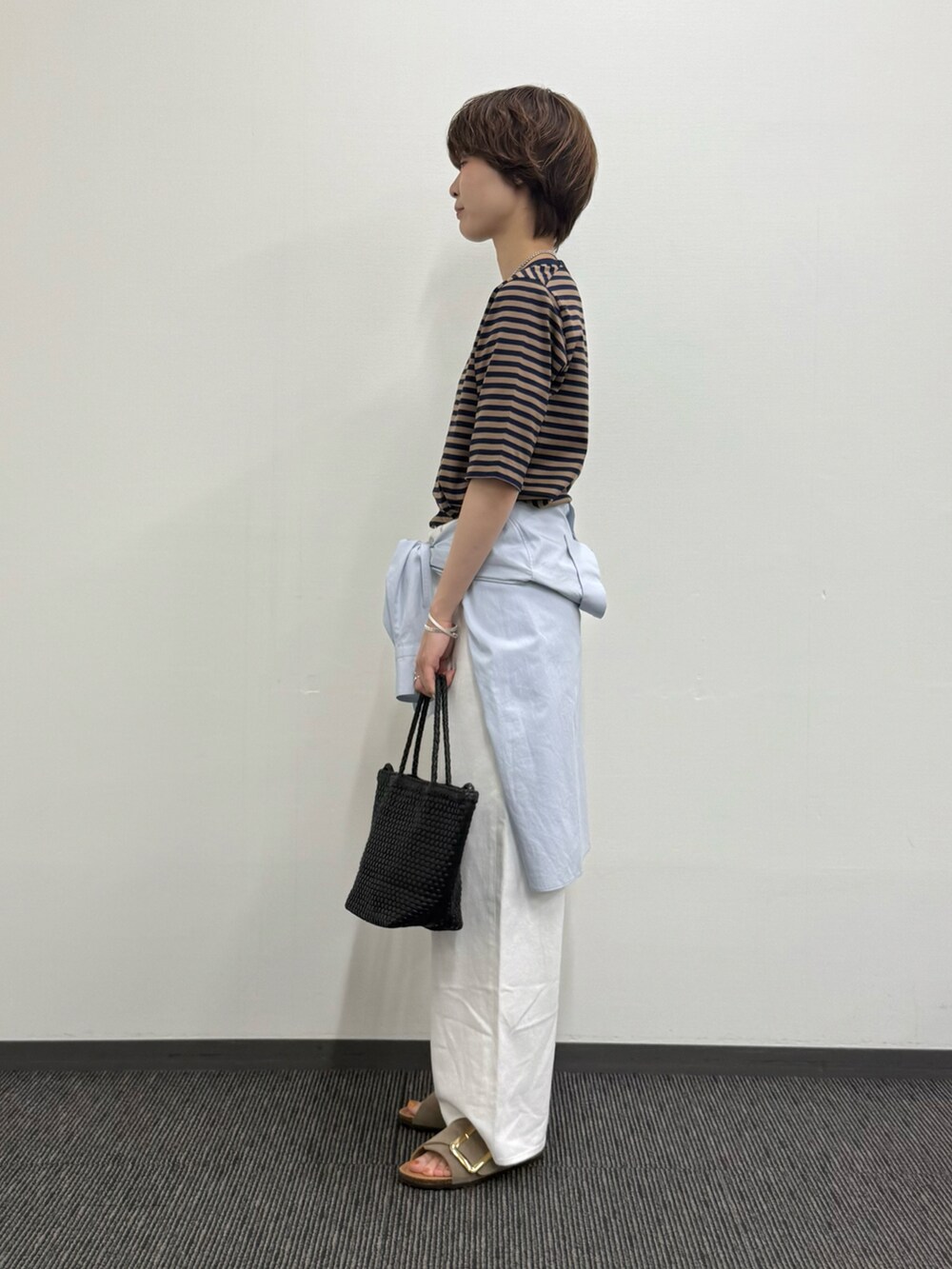 ベージュ系のTシャツ/カットソー、ブルー系のシャツ/ブラウス、ホワイト系のデニムパンツを着用したレディースの夏コーディネートの2枚目の写真