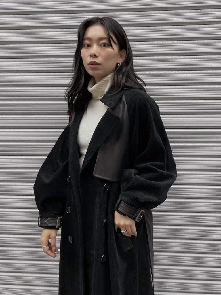 ブラック系のブーツ、ブラック系のデニムパンツ、ブラック系のトレンチコートを着用したレディースの秋コーディネートの4枚目の写真