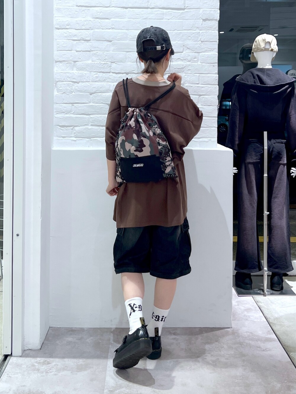 ブラック系のデニムパンツ、ブラウン系のワンピース、その他のバックパック/リュックを着用したレディースの春コーディネートの2枚目の写真