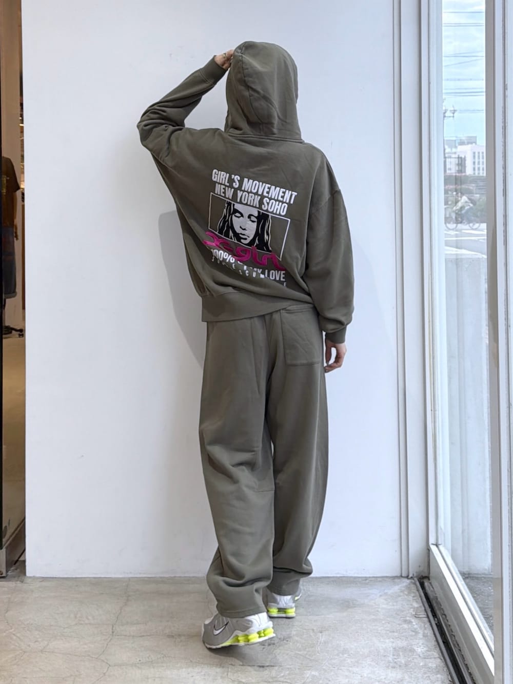 グリーン系のスウェットパンツ、グリーン系のパーカー、ブラック系のサングラスを着用したレディースの夏コーディネートの2枚目の写真