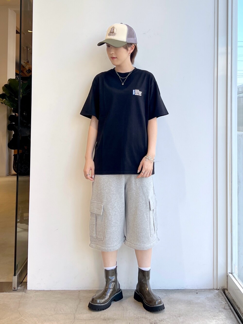 グレー系のスウェットパンツ、ブラック系のTシャツ/カットソー、ベージュ系のキャップを着用したレディースの夏コーディネートの2枚目の写真