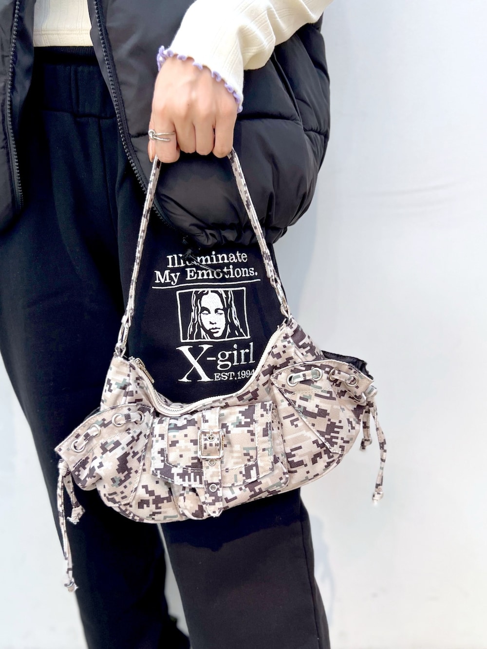 ブラック系のスウェットパンツ、ブラック系のダウンベスト、ホワイト系のTシャツ/カットソーを着用したレディースの秋コーディネートの6枚目の写真