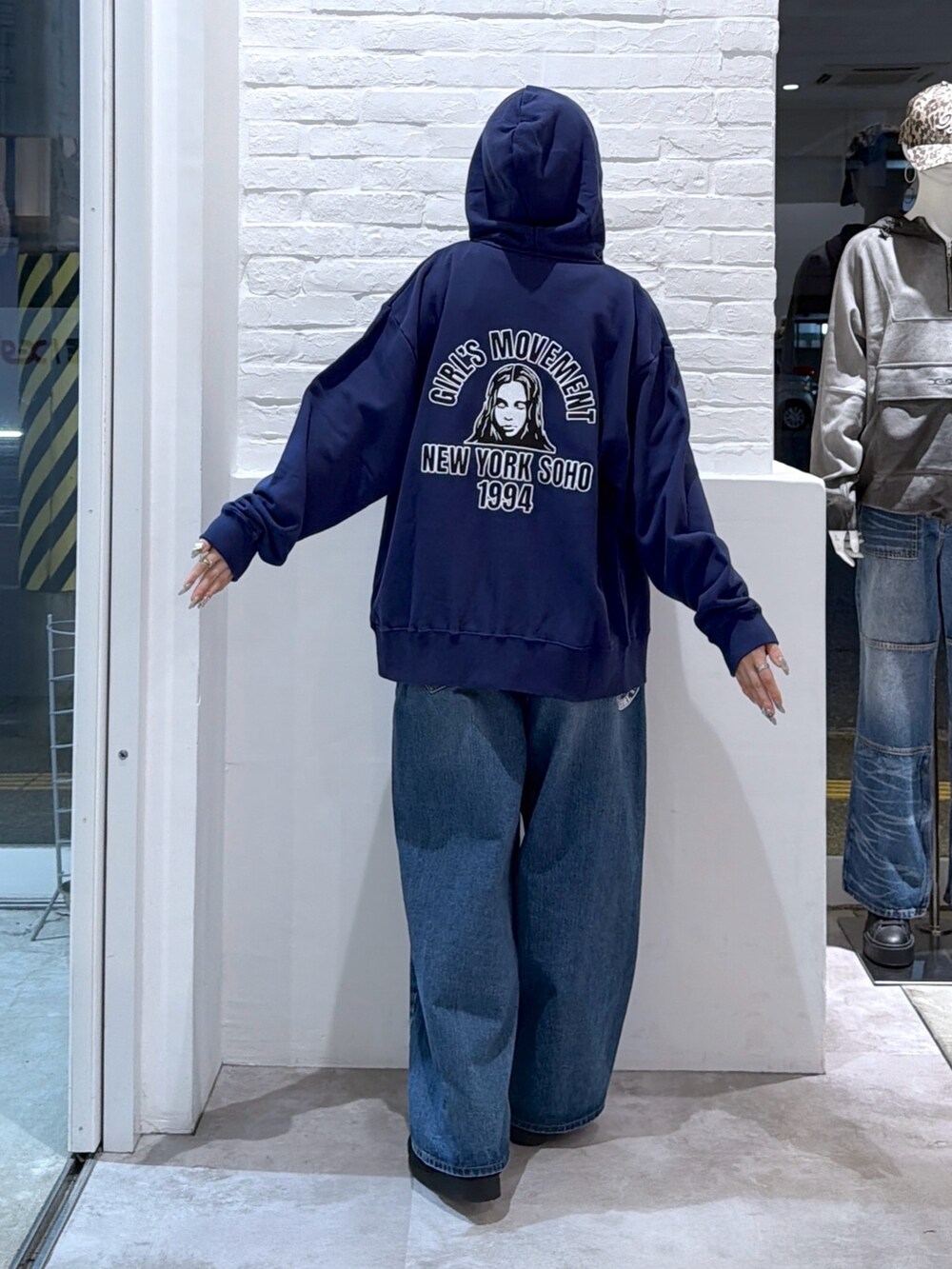 ブルー系のデニムパンツ、ホワイト系のTシャツ/カットソー、ブルー系のパーカーを着用したレディースの秋コーディネートの2枚目の写真
