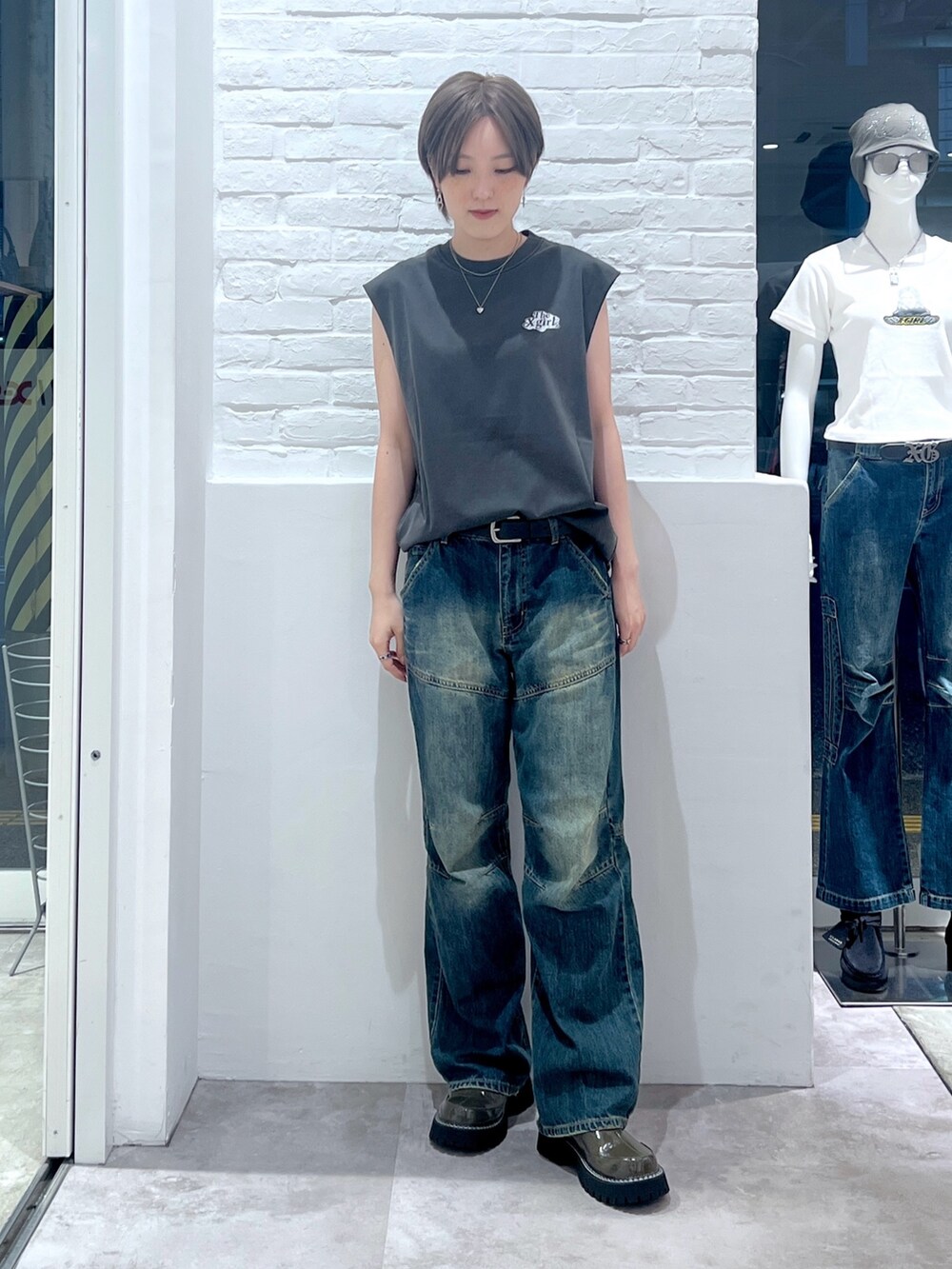 ブルー系のデニムパンツ、ブラック系のタンクトップを着用したレディースの夏コーディネートの2枚目の写真