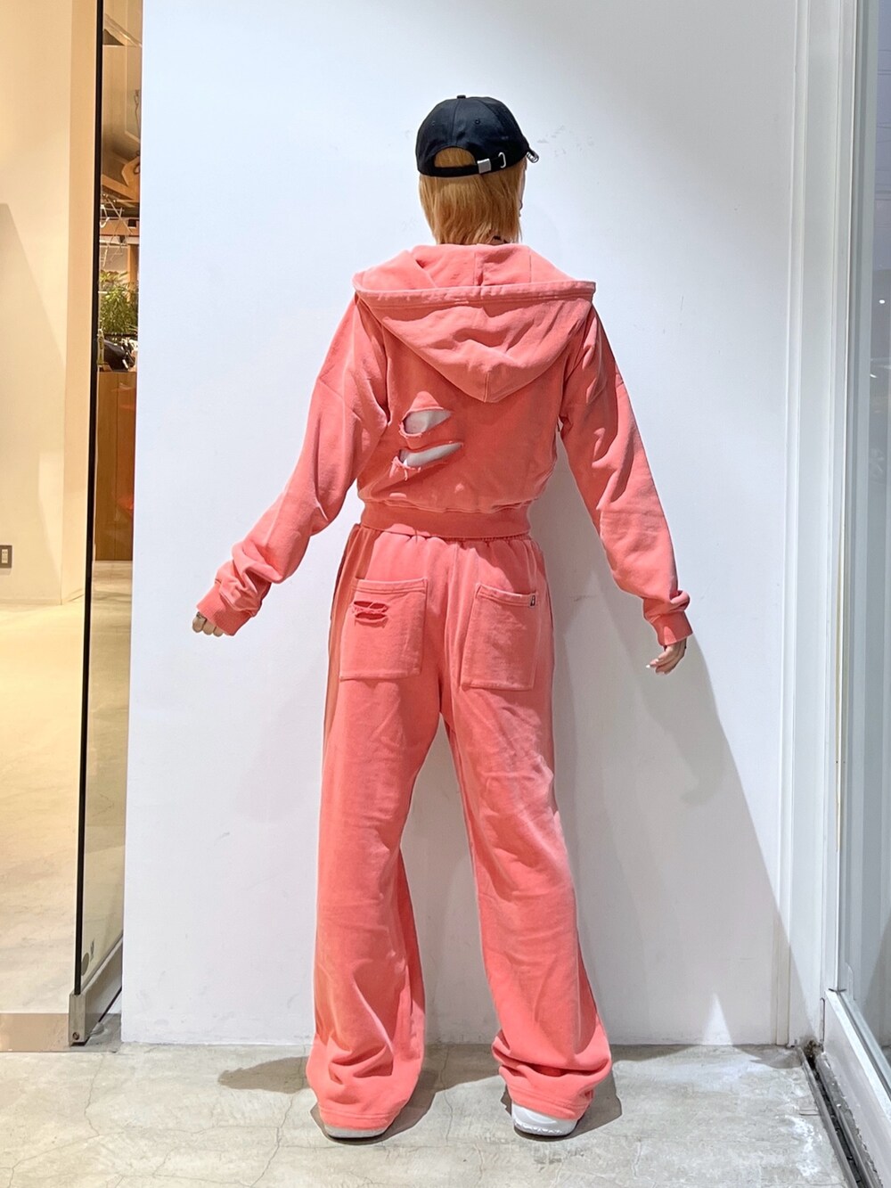 オレンジ系のスウェットパンツ、オレンジ系のパーカー、ホワイト系のTシャツ/カットソーを着用したレディースの春コーディネートの2枚目の写真