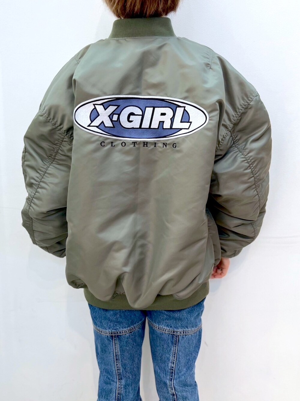 「x-girl、ストリート、ファッションを楽しもう、ビッグシルエット、ショート丈トップス、MA-1、ジャケット、ジャケットスタイル、デニムパンツ、パンツスタイル、ムートンブーツ、冬コーデ、マイベストコーデ2023」｜「X-girlのSIDE ZIP DENIM PANTS（デニムパンツ、ブルー系）」を使った、小島えみるさん（レディース・165cm）の秋コーディネートの5枚目の写真