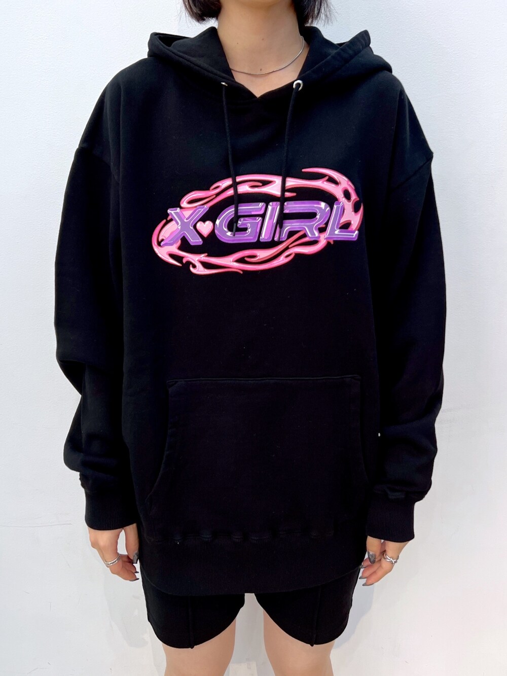 ブラック系のスウェットパンツ、パープル系のハンドバッグ、ブラック系のパーカーを着用したレディースの秋コーディネートの3枚目の写真