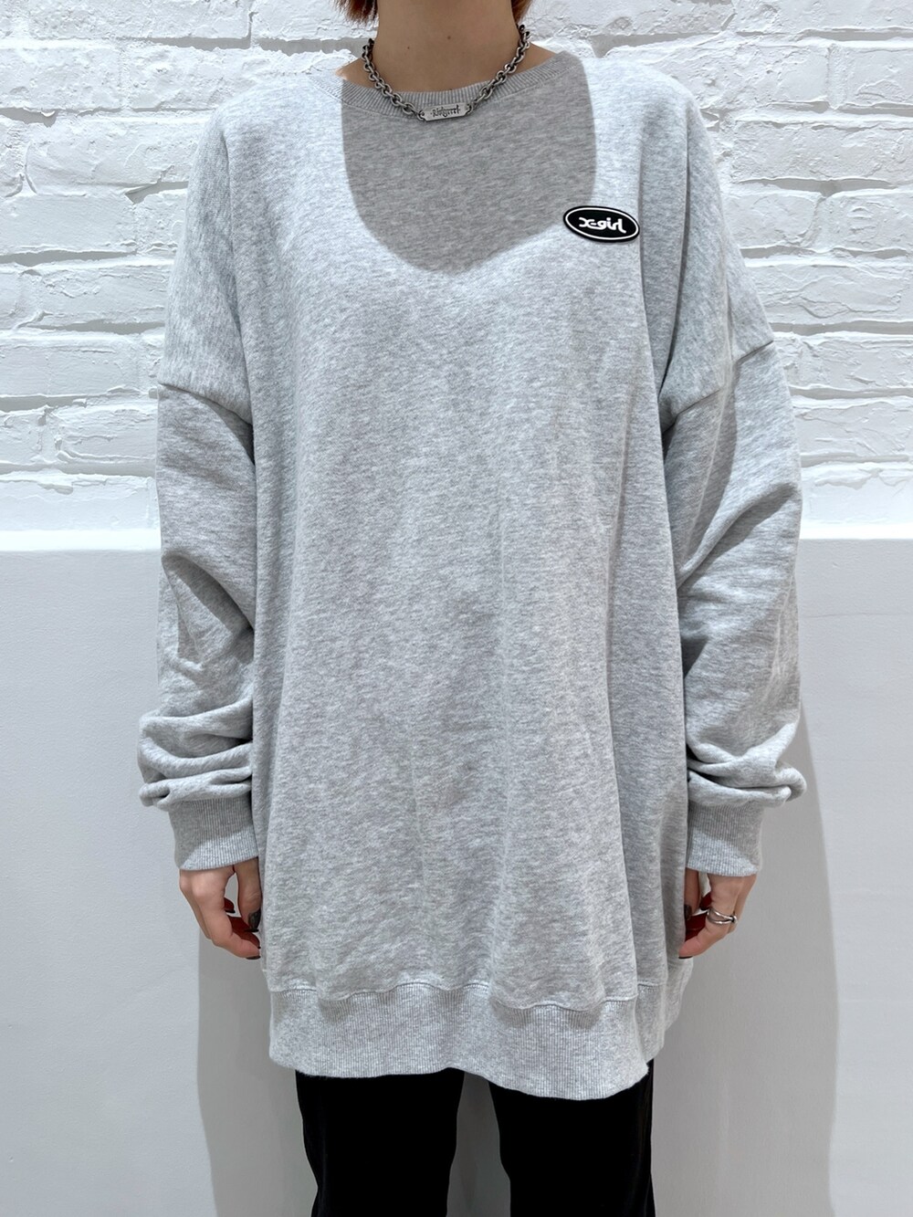 グレー系のスウェット、ブラック系のデニムパンツ、ブルー系のショルダーバッグを着用したレディースの春コーディネートの3枚目の写真