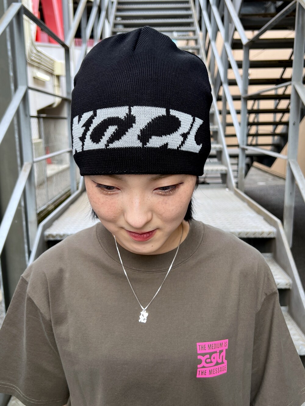 グレー系のスウェットパンツ、グリーン系のTシャツ/カットソー、ブラック系のニットキャップ/ビーニーを着用したレディースの夏コーディネートの8枚目の写真