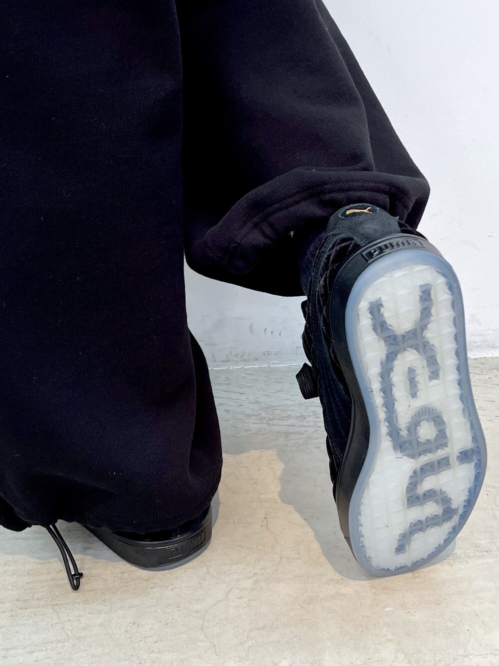 レッド系のスウェット、ブラック系のスウェットパンツ、ブラック系のスニーカーを着用したレディースの秋コーディネートの8枚目の写真