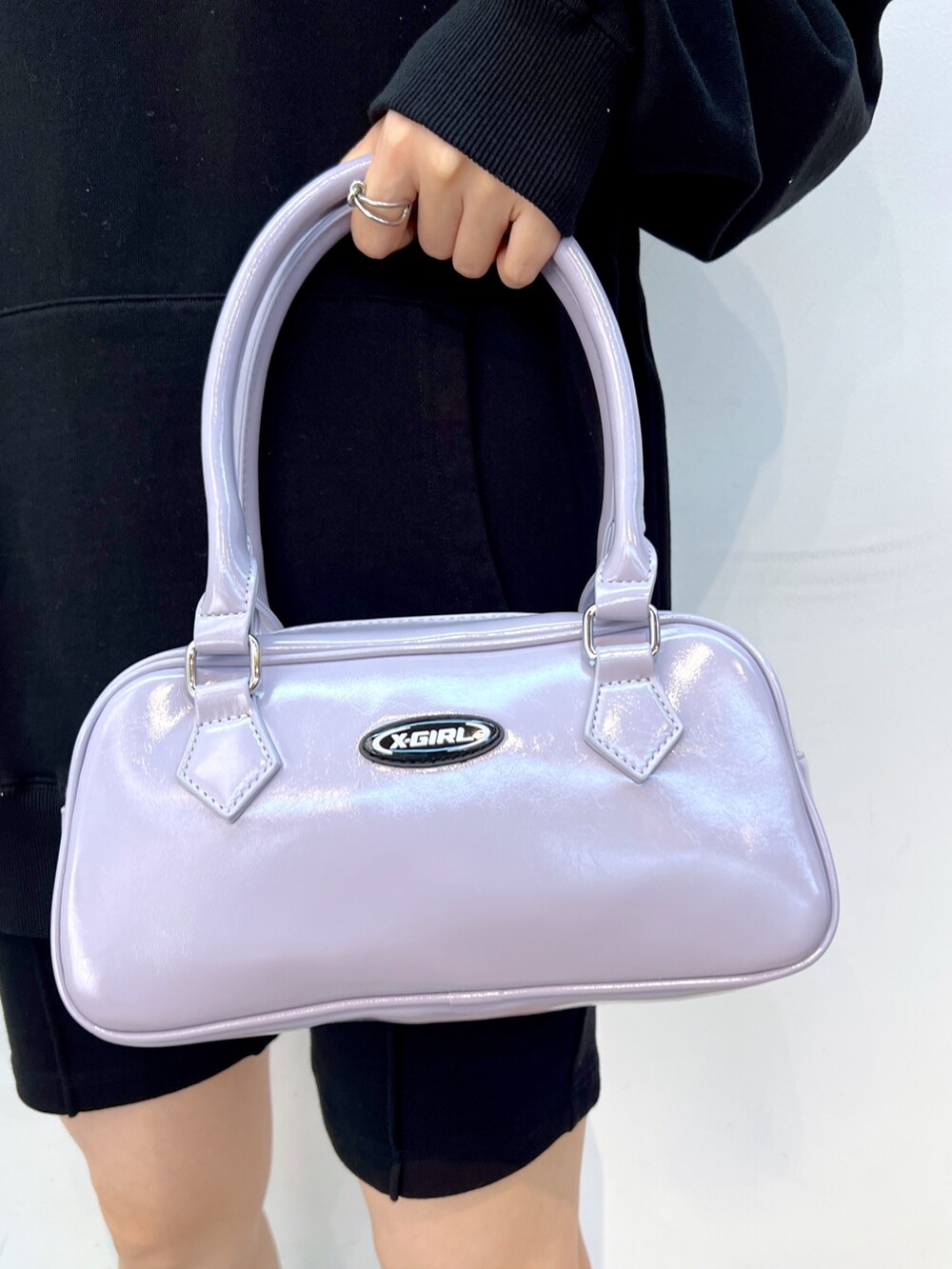 ブラック系のスウェットパンツ、パープル系のハンドバッグ、ブラック系のパーカーを着用したレディースの秋コーディネートの6枚目の写真