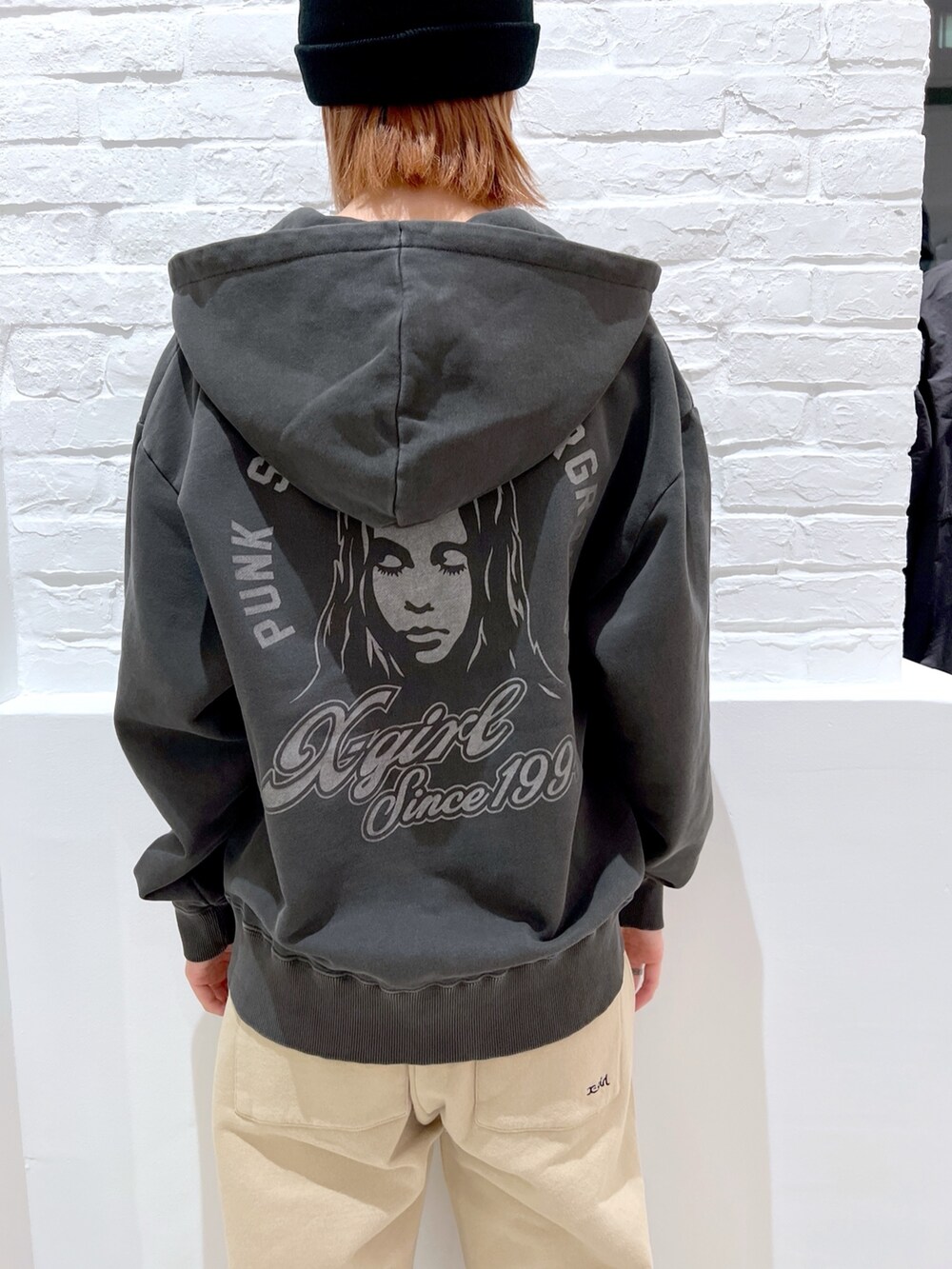 ベージュ系のスウェットパンツ、ブラック系のパーカー、ブラック系のニットキャップ/ビーニーを着用したレディースの春コーディネートの4枚目の写真