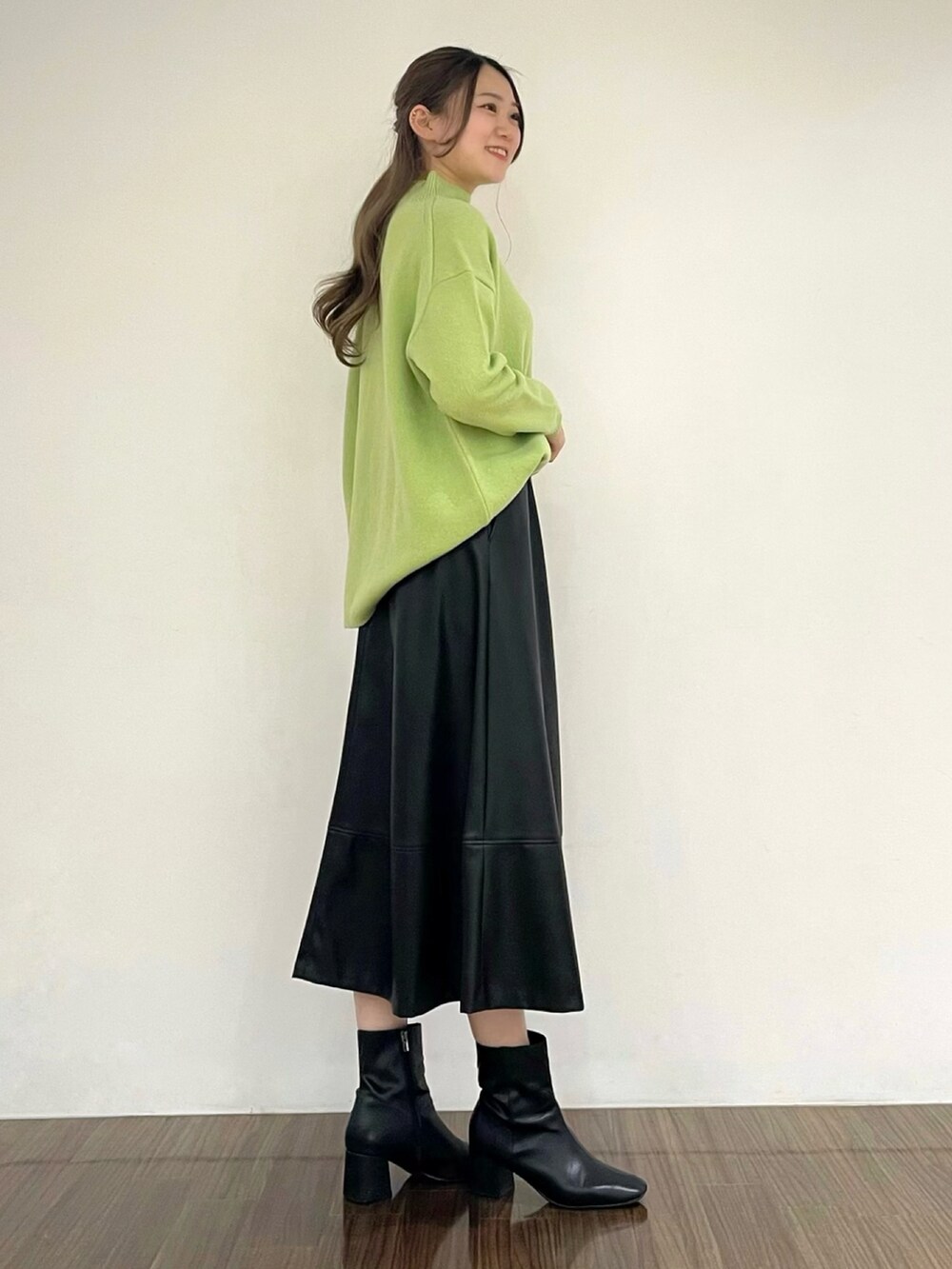グリーン系のニット/セーター、ブラック系のスカート、その他のその他を着用したレディースの秋コーディネートの3枚目の写真