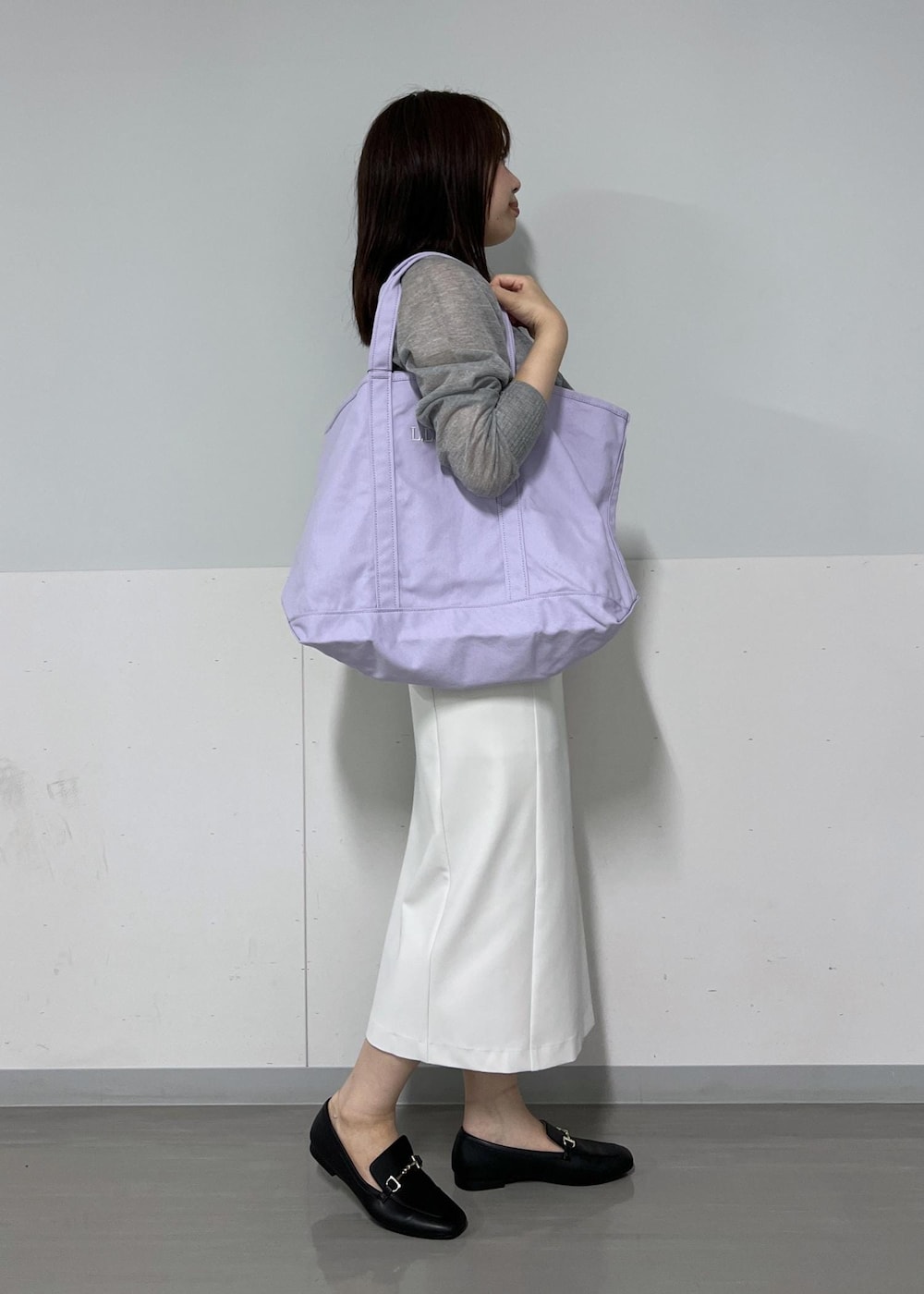 シルバー系のカーディガン/ボレロ、ホワイト系のジャンパースカート、パープル系のトートバッグを着用したレディースの夏コーディネートの4枚目の写真