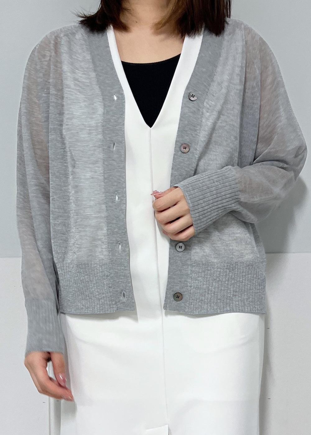 シルバー系のカーディガン/ボレロ、ホワイト系のジャンパースカート、パープル系のトートバッグを着用したレディースの夏コーディネートの5枚目の写真