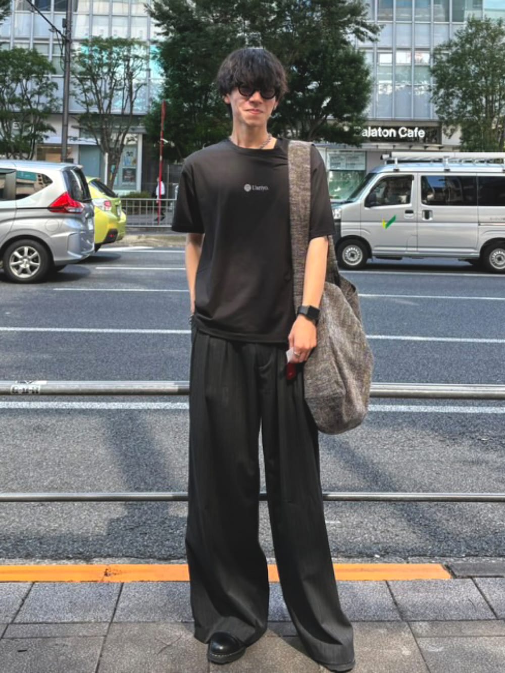 グレー系のスラックス、ブラック系のドレスシューズ、グレー系のショルダーバッグを着用したメンズの秋コーディネートの2枚目の写真