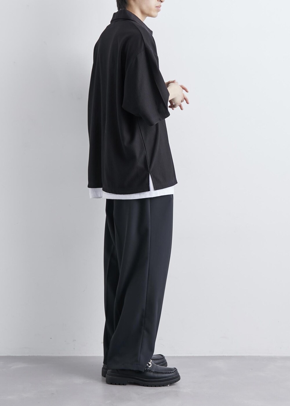 ブラック系のTシャツ/カットソー、ブラック系のスラックスを着用したメンズの夏コーディネートの2枚目の写真